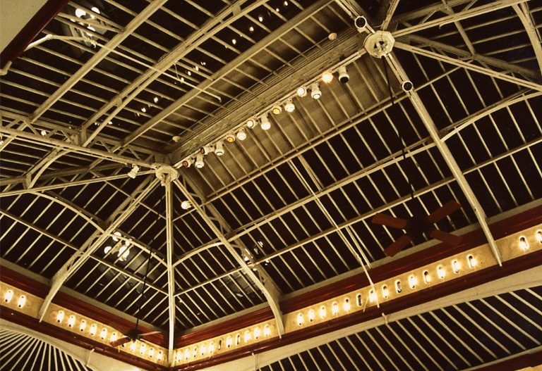 The “functional” lighting – track fixtures located at the apex of the ceiling – can be seen in this photo. You can also see the band of light created by using the original vent holes as decorative light fixtures.