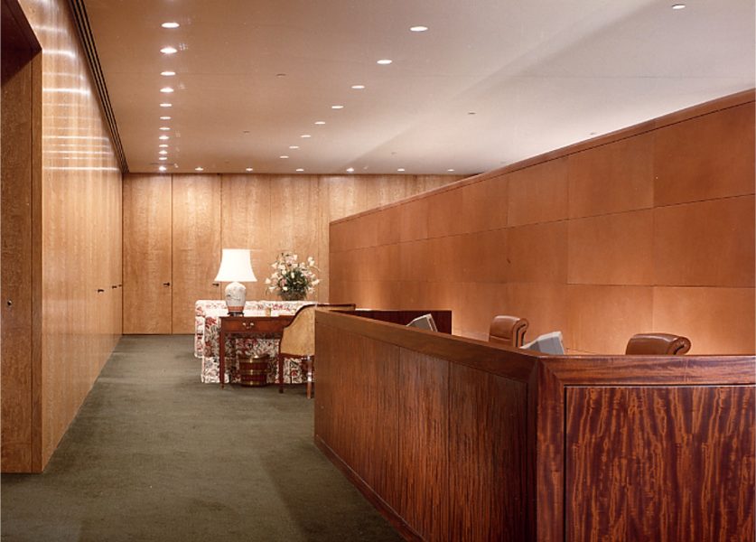 Commercial Credit Corporation occupies the top two floors of a NYC skyscraper. The upper (executive) floor has extremely high-end finishes and furnishings. The 3’ wide X 11’ high panels in the reception area were faced with Japanese maple burl veneer. Note the use of wall washers to evenly illuminate these panels.